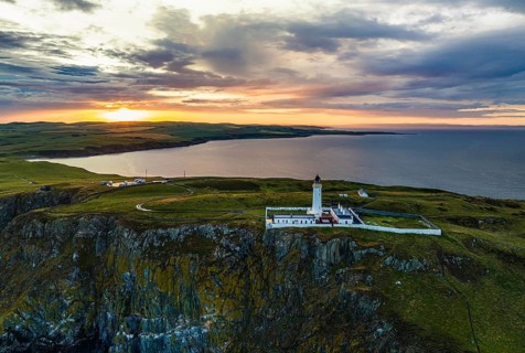 Sunset over Mull of Galloway Lighthouse from a drone, Mainland Scotland, Scotland, UK