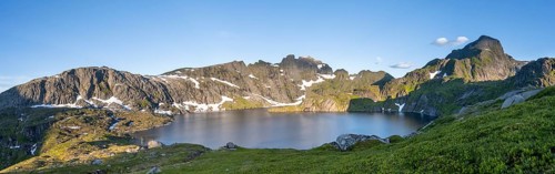 Mountain landscape with lake Krokvatnet, in the back mountain peak Helvetestinden, at sunrise,