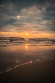 Beach with waves by the sea at sunset, Zandvoort, Netherlands