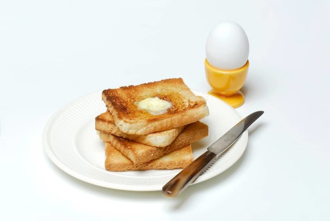 Toast, melting butter, breakfast egg, toast, plate, knife, egg cup, egg