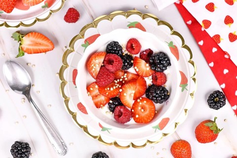 Top view of berry mix yogurt bowl with strawberry, raspberry and blackberry fruits and puffed