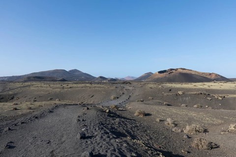 Path through the volcanic landscape to the Caldera de Los Cuervos volcano, Tias, Lanzarote, Canary