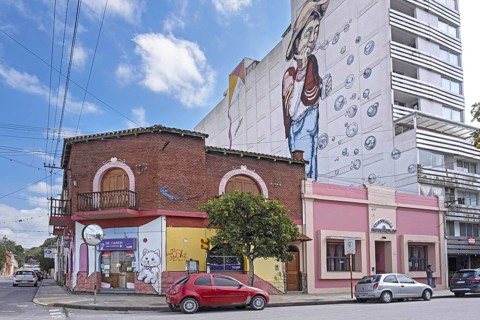 Giant wall painting on apartment's side and graffiti artwork in the city San Salvador de Jujuy,