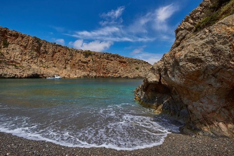 Menies, Rodopou, dream bay, single boat at anchor, spray, rocks, pebble beach, crystal clear sea,