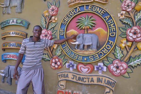 Tour guide standing at the Sierra Leone Peace and Cultural Monument, Freetown, Sierra Leone, Africa