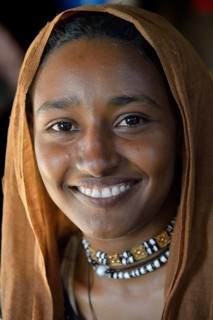 Young girl from a nomadic tribe, wearing headgear, portrait, Bayuda Desert, in Karima, Nubia,