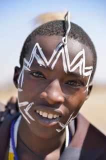 Young Maasai warrior with a painted face, Ngorongoro Conservation Area, Ndema, Tanzania, Africa