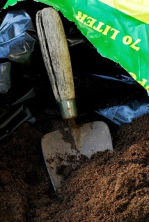 Bag of potting soil, shovel, growing soil