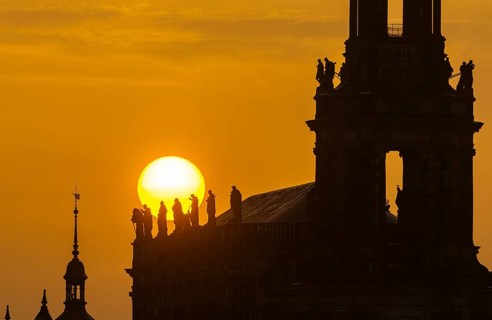 Sunset in Dresden. The sun disc, particularly orange due to the Sahara dust, sets behind the