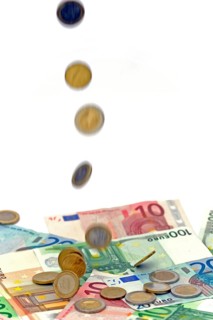 Euro coins fall on euro banknotes, rain of money, high cost, symbolic image