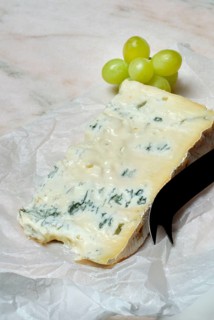 Gorgonzola cheese with cheese knife and grapes, blue cheese, noble mould