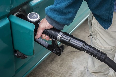 Close up of man pumping diesel fuel into his vehicle at service station