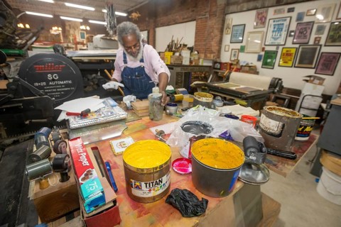 Detroit, Michigan, Amos Kennedy works in his letterpress printing shop. Kennedy prints posters and