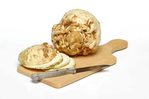 Celery (Apium graveolens) tubers and s lices, knives