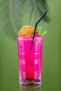 Cold lemonade with dragon fruit, orange and coconut juice on green background