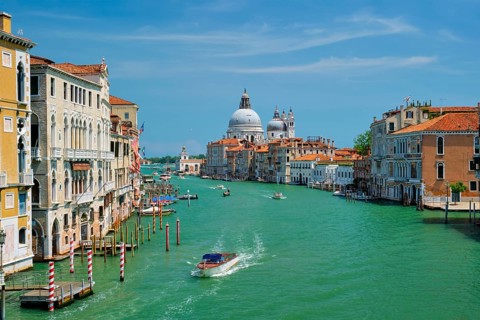 View of Venice Grand Canal with boats and Santa Maria della Salute church in the day from Ponte