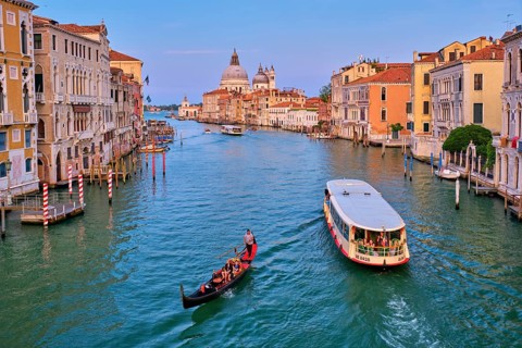 VENICE, ITALY, JULY 19, 2019: View of Venice Grand Canal with boats gondola and vaporetto and Santa