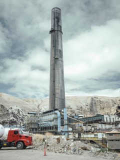 Chimney of the smelter, in the foreground a spoil heap contaminated with heavy metal residues, La