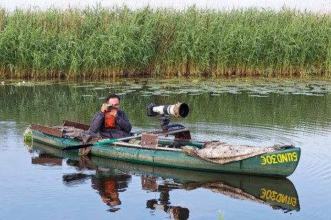 Nature park photographer in a kayak on the river Trebel at work, Naturpark Flusslandschaft