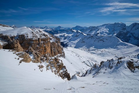 View of a ski resort piste and Dolomites mountains in Italy from Passo Pordoi pass. Arabba, Italy,