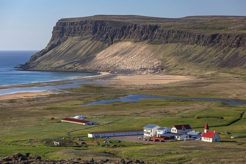 Farm and church, sea, beach, mountains, sunny, summer, Breidavik, Westfjords, Iceland, Europe