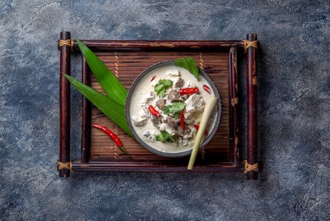 Thai chicken mushroom coconut milk soup TOM KHA GAI in bowl with thai spices