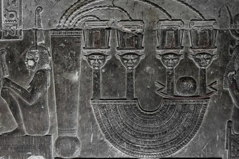 Hieroglyphic carvings on the wall of an ancient egyptian temple