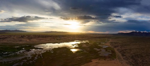 Aerial panorama of the sand dunes Elsen Tasarhai (Bayan Gobi) and lake at sunset in Mongolia