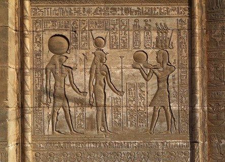 Hieroglyphic carvings on the exterior walls of an ancient egyptian temple