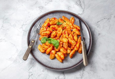 Food, Traditional Italian potato Gnocchi with tomato sauce and fresh basil on gray plate, marbled