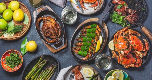 Food Photography, Set table with seafood dishes, cooked crabs, tiger shrimps, grilled octopus and