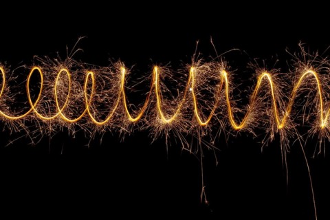 Spiral lights with sparks on a black background. Christmas lights on a long exposure