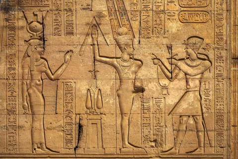 Hieroglyphic carvings on the exterior walls of an ancient egyptian temple