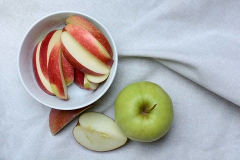 Apple and apple slices in peel, sliced apple
