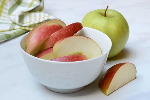 Apple and apple slices in peel, sliced apple