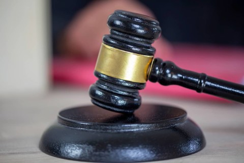 Symbolic image of a court hearing: close-up of a judge's gavel