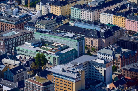 Aerial view of a city with densely packed buildings in different colours and styles, urban