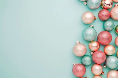 Christmas flatlay with blue and pink colored tree baubles on pastel background with copy space.