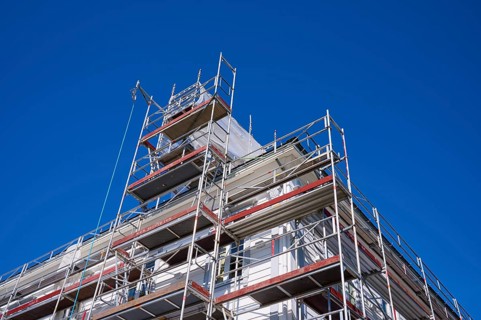 Scaffolding in front of a building under a clear blue sky, Fløibanen mountain station, Bergen,