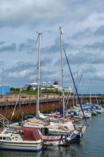 Sailing yachts in the north-east harbour, passenger ship MS Maud of Hurtigruten AS, offshore island