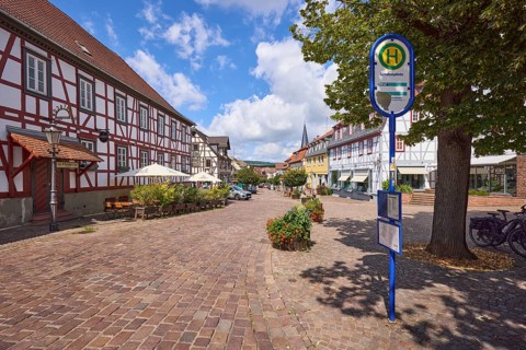 Lindenplatz with bus stop, restaurant and cobbled street in Michelstadt, Odenwald, Odenwaldkreis,