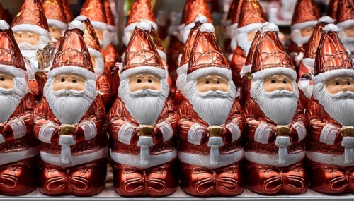 Symbol image for chocolate Santas wrapped in aluminium foil, cheerful looking Santas lined up on a