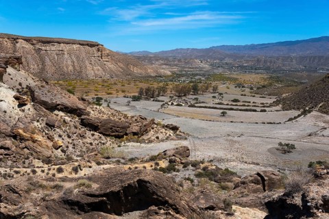 Gorge in a dry mountain landscape with rocks and a clear blue sky, Llano de Buho, Tabernas Desert,