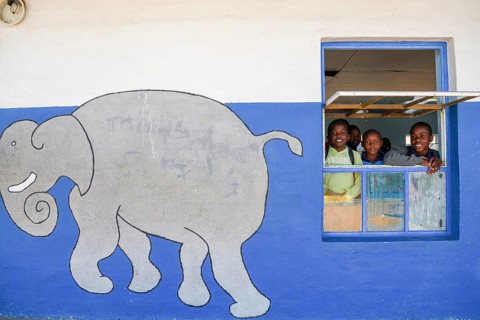 Children look out of the window of their classroom at Gariseb Primary School, boarding school for