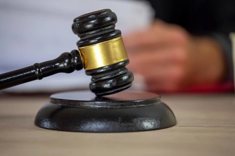 Symbolic image of a court hearing: close-up of a judge's gavel