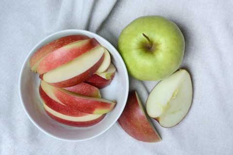 Apple and apple slices in peel, sliced apple