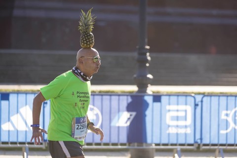 Pineapple Marathon Runner (Moshe Lederfein) balances a pineapple on his head during the run at the