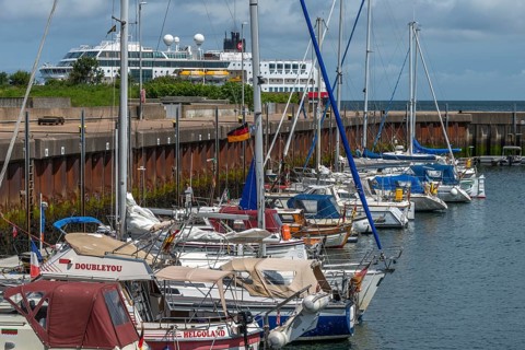 Sailing yachts in the north-east harbour, passenger ship MS Maud of Hurtigruten AS, offshore island
