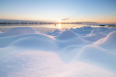 Winter lake at sunrise, many snow hills and icy atmosphere, Seegarten, Allensbach, Lake Constance,