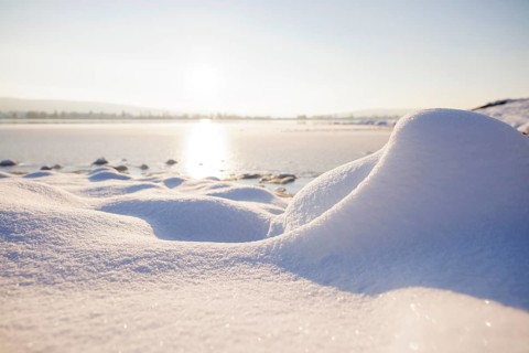 Snow covers the ground as the sun sets over a wintry lake, Seegarten, Allensbach, Lake Constance,